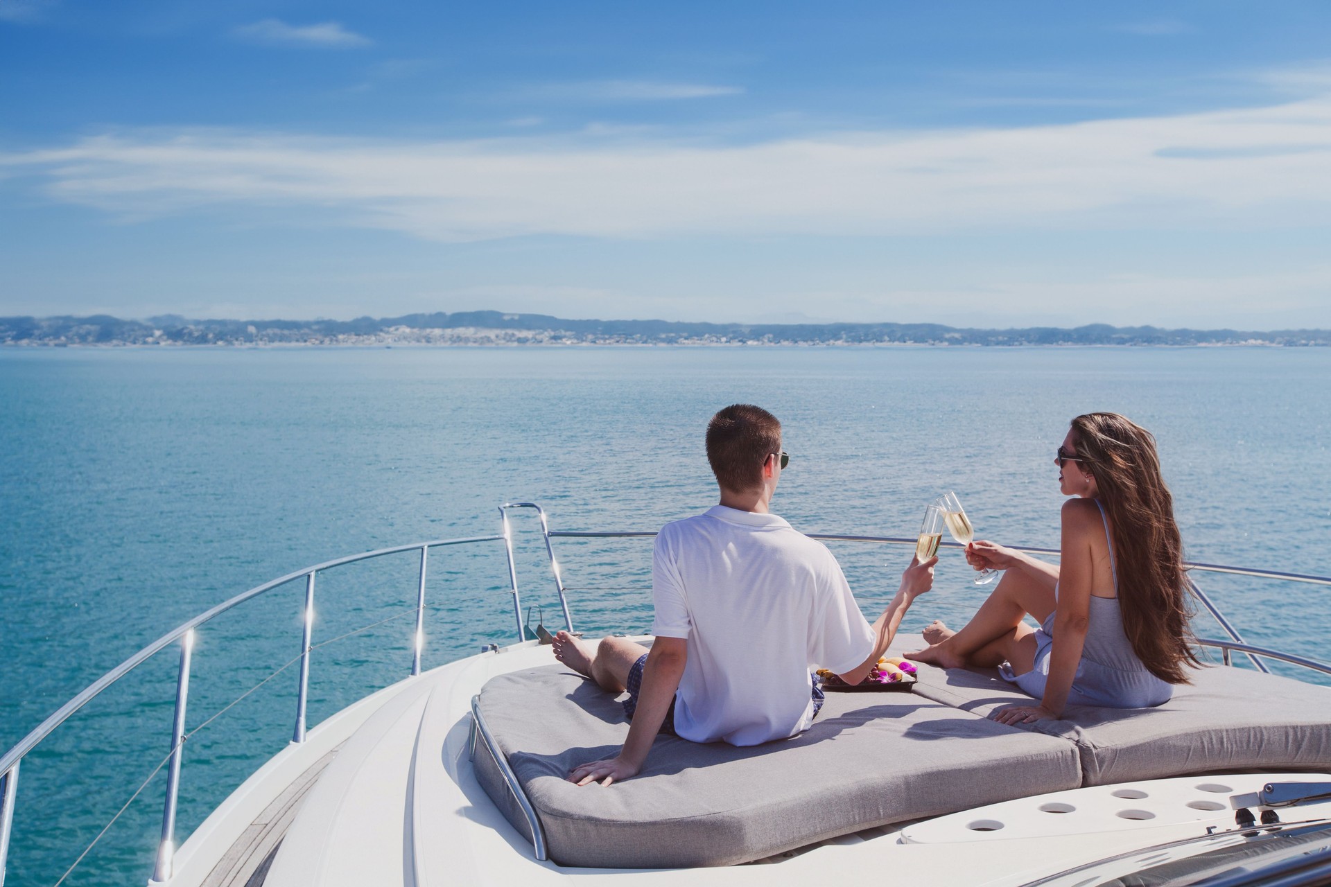couple drinking champagne on luxury boat, luxurious yacht cruise